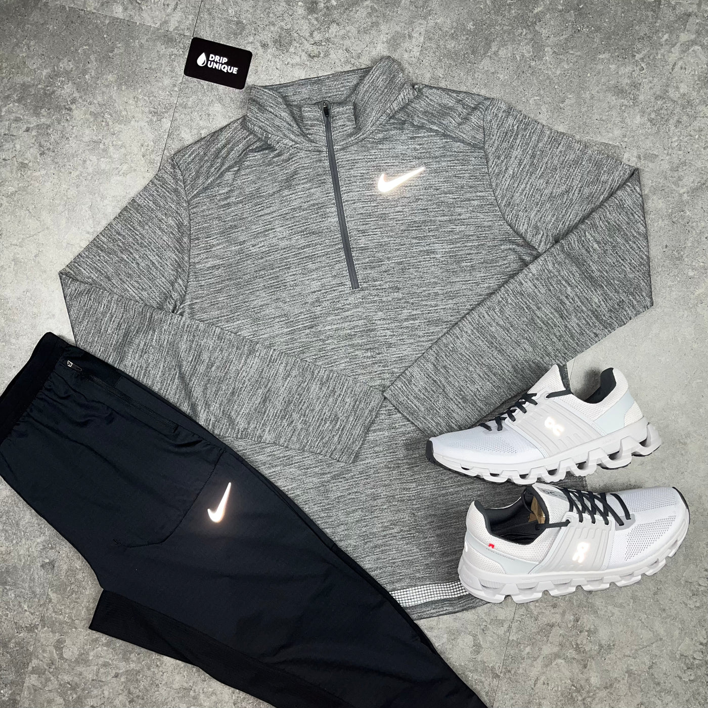Men's Nike Pacer 1/4 Zip Top in a Grey colourway close up, paired with the black nike phenom Pants and the white On Running Cloudswift 3's, dripuniqueuk