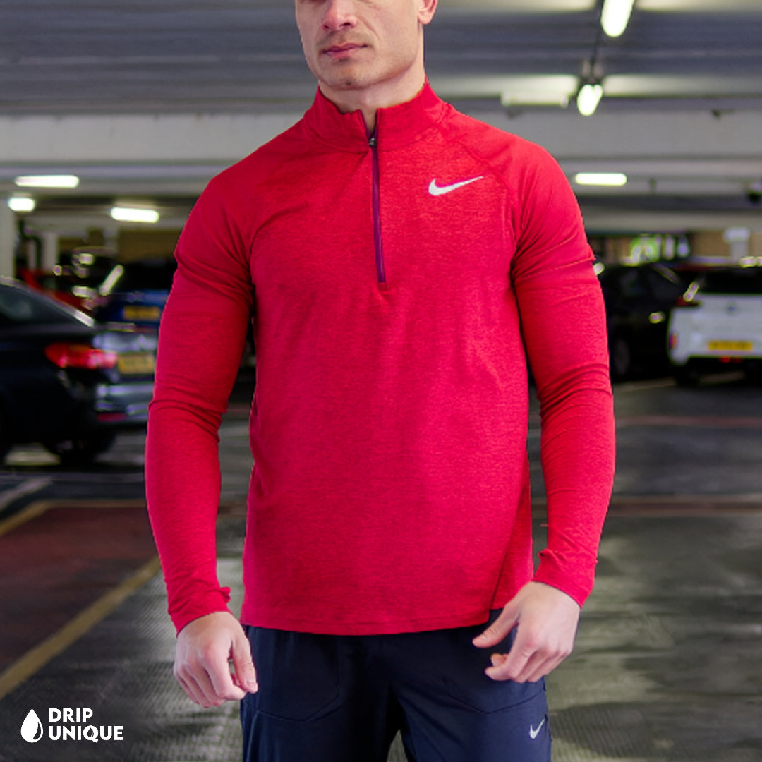Men's Nike Therma 1/4 Zip Top in a Red colourway, being modelled, showcasing the front design of the nike therma 1/4 zip in red and the black nike elite phenom pants, dripuniqueuk